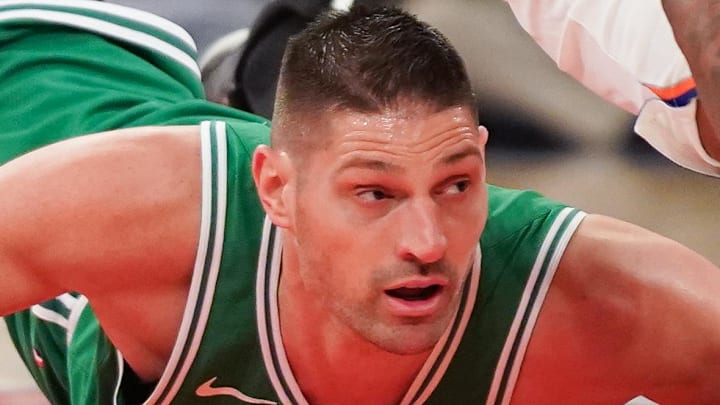 Apr 9, 2026; New York, New York, USA; New York Knicks center Mitchell Robinson (23) wins a loose ball from Boston Celtics center Nikola Vucevic (4) during the first half at Madison Square Garden. Mandatory Credit: Lucas Boland-Imagn Images
