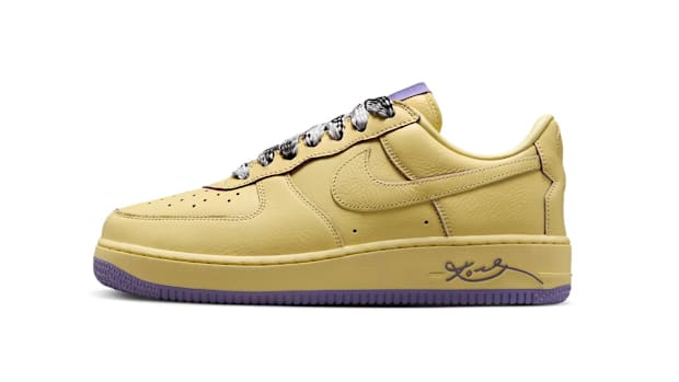 Side view of yellow and purple Nike sneakers.
