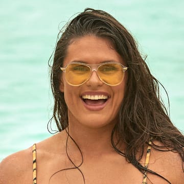 Ilona Maher was photographed by Ben Watts in Bermuda. Swimsuit by Tropic of C. Sunglasses by Bonnie Clyde.