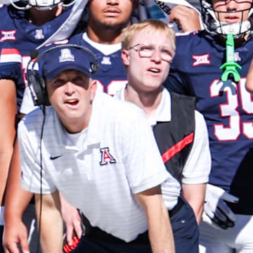 Nov 8, 2025; Tucson, Arizona, USA; Arizona Wildcats head coach Brent Brennan watches the game from the sidelines during the first quarter against the Kansas Jayhawks at Arizona Stadium. Mandatory Credit: Aryanna Frank-Imagn Images