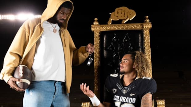 Shedeur Sanders hands the proverbial keys to Carrollton (Georgia) five-star quarterback Julian Lewis during a visit.