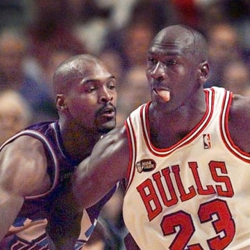 June 12, 1998; Chicago, IL, USA; Chicago Bulls guard Michael Jordan (23), right, goes up against Utah Jazz player Bryon Russell (3) in Game 5 of the 1998 NBA Finals.  Mandatory Credit: Anne Ryan-USA TODAY