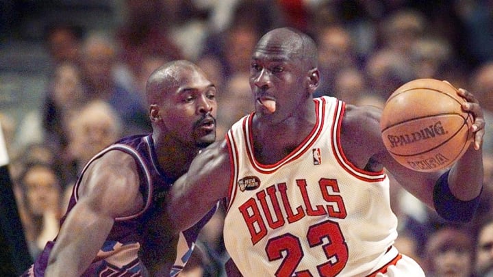 June 12, 1998; Chicago, IL, USA; Chicago Bulls guard Michael Jordan (23), right, goes up against Utah Jazz player Bryon Russell (3) in Game 5 of the 1998 NBA Finals.  Mandatory Credit: Anne Ryan-USA TODAY