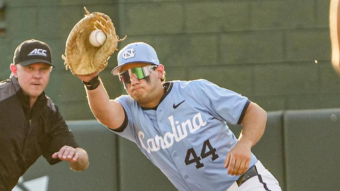 Clemson outfielder Bryce Clavon (1) dives back to first under the tag of University of North Carolina junior Erik Paulsen (44) during the bottom of the third inning at Doug Kingsmore Stadium in Clemson, S.C. Friday, April 10, 2026.