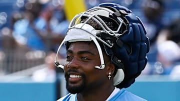 Tennessee Titans wide receiver Treylon Burks stretches during “Back Together Weekend” training camp practice.