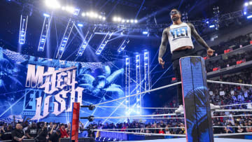 Jey Uso climbs up the middle rope during his entrance on WWE Monday Night Raw.