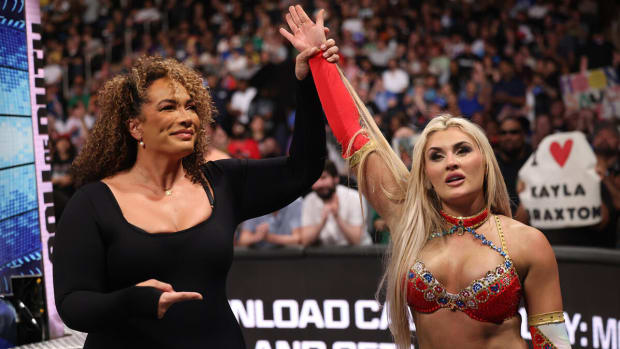 Tiffany Stratton has her hand raised by Nia Jax after qualifying for the WWE women's Money in the Bank 2024 match.