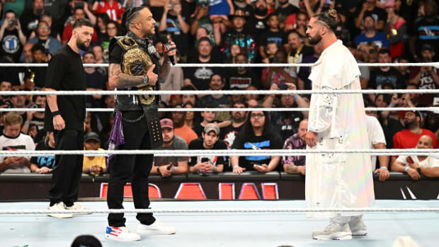 World Heavyweight Champion Damian Priest (with Finn Balor) in the ring with Seth Rollins on WWE Raw.