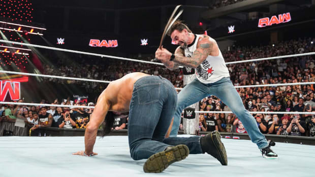 CM Punk whips Drew McIntyre with his own belt during the August 12, 2024 episode of WWE Monday Night Raw.