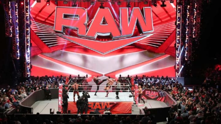 A tag team match in progress during an episode of WWE Monday Night Raw.