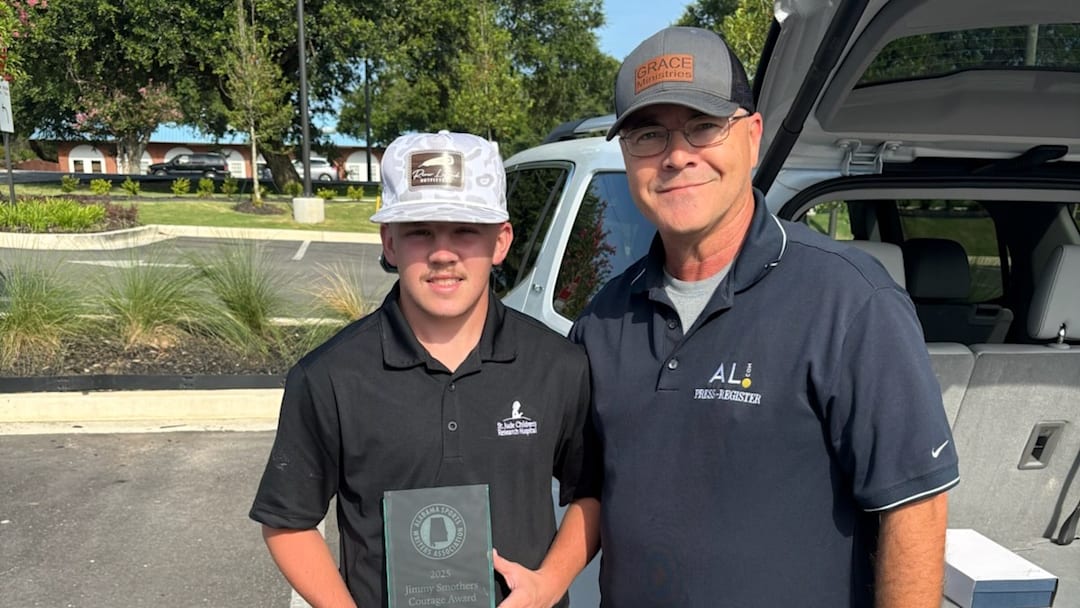 Fruitdale baseball player Sid Hobbs receives the Jimmy Smothers Courage Award by Ben Thomas of the Alabama Sports Writers Association.