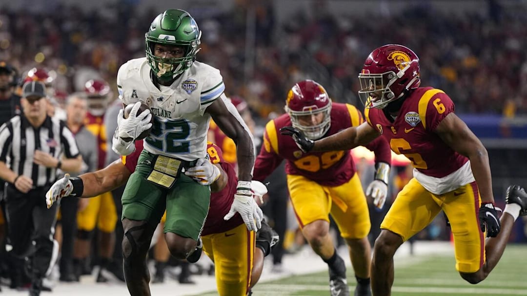 Green Wave RB Tyjae Spears running away from defenders in a win against the Trojans in a Cotton Bowl Victory.