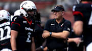 Cincinnati Bearcats head coach Scott Satterfield speaks with Cincinnati Bearcats quarterback Brendan Sorsby (2) before the College Football game between the Cincinnati Bearcats and the Houston Cougars at Nippert Stadium in Cincinnati on Saturday, Sept. 21, 2024.