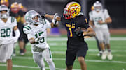 Mission Viejo's Phillip Bell tries to shed a De La Salle defender during the 2023 CIF D1-AA state title game