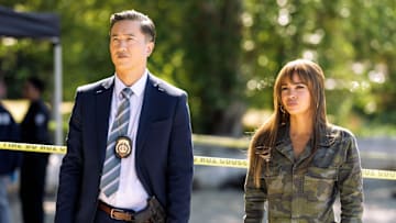 Wild Cards -- “Strangers on a Wave” -- Image Number: WCD104b_0108r -- Pictured (L-R) : Terry Chen as Chief Li and Vanessa Morgan as Max -- Photo Credit: Ed Araquel/The CW -- © 2024 The CW Network, LLC. All Rights Reserved.