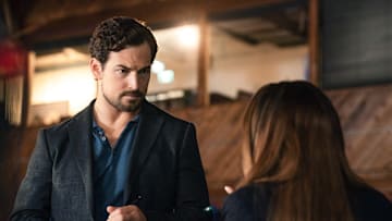 Wild Cards -- “Show Me the Murder” -- Image Number: WCD102b_0166r -- Pictured (L-R) : Giacomo Gianniotti as Ellis and Vanessa Morgan as Max -- Photo Credit: Katie Yu/The CW -- © 2023 The CW Network, LLC. All Rights Reserved.