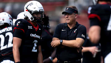Cincinnati Bearcats head coach Scott Satterfield speaks with Cincinnati Bearcats quarterback Brendan Sorsby (2) before the College Football game between the Cincinnati Bearcats and the Houston Cougars at Nippert Stadium in Cincinnati on Saturday, Sept. 21, 2024.