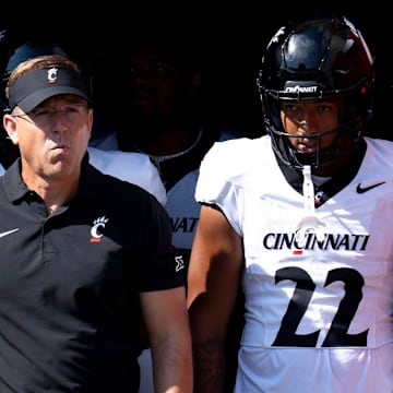 Cincinnati Bearcats head coach Scott Satterfield and Cincinnati Bearcats linebacker Jonathan Thompson (22) prepare to take the field before the College Football game against the Miami Redhawks at Yager Stadium in Cincinnati on Saturday, Sept. 14, 2024.