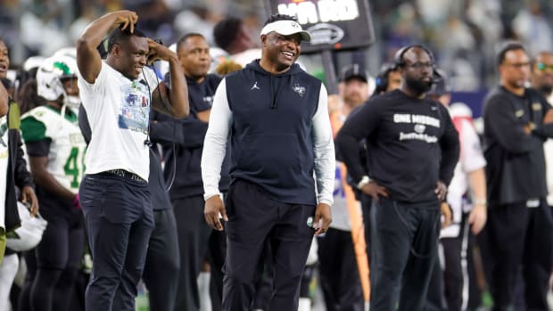 DeSoto coach Claude Mathis flashes a grin during the 2023 UIL 6A Division II state championship.