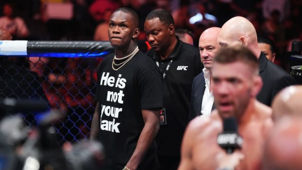 Israel Adesanya watches on as Dricus Du Plessis has his post-fight interview following a UFC bout.