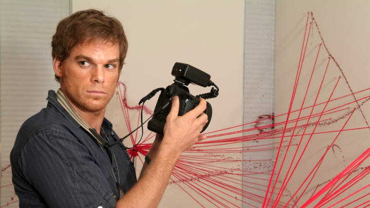 Michael C. Hall as Dexter Morgan taking a picture in Dexter season 1