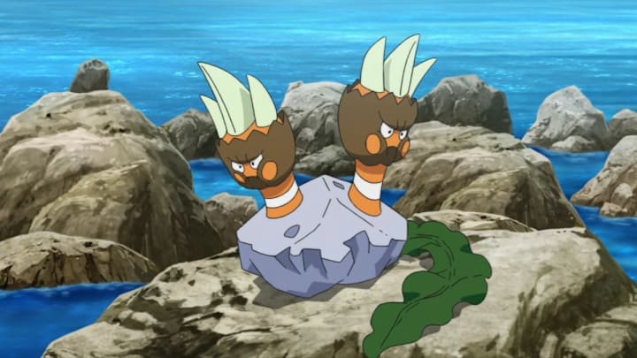 A Pokémon that has two hand-like limbs coming out of a rock, both of which have angry faces.