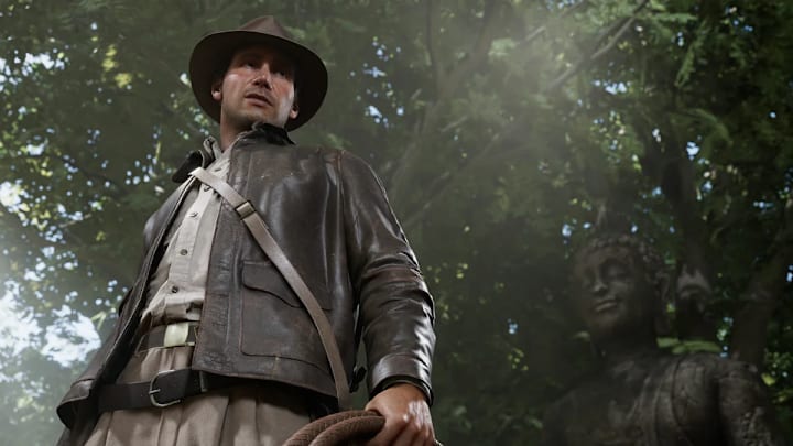 Indy hold a whip in the jungle in Indiana Jones and the Great Circle