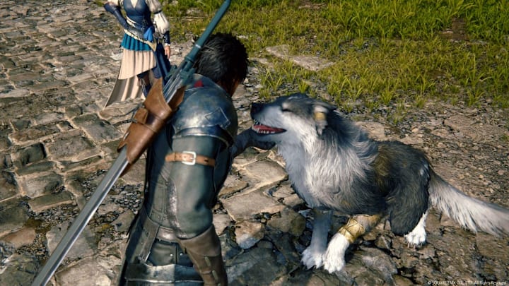 Clive pets his dog in Final Fantasy 16