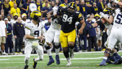 Iowa's Yahya Black (94) chases Michigan quarterback J.J. McCarthy during the 2023 Big Ten Championship game in Indianapolis. 