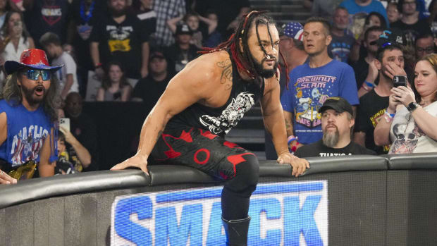 Jacob Fatu hops the barricade during an episode of WWE Friday Night SmackDown to assist The Bloodline.