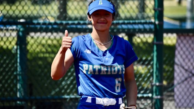 Kaila Siu gives the thumbs-up on Liberty's performance in the Class 3A softball championships.