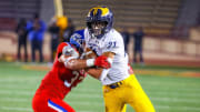 Oak Ridge tight end Kaleb Edwards fights off a Folsom defender in the Sac-Joaquin Section championship game