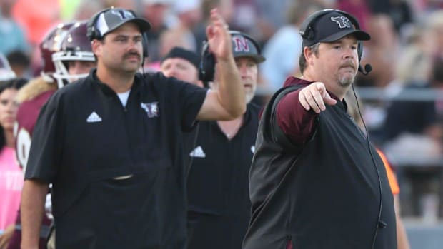 Head coach Grant Thompson adjusts a play during the Niceville South Sumter football game at Niceville.