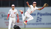 Corona's Billy Carlson leaps over a baserunner during the Southern Section Division 1 championship game against Harvard-Westlake
