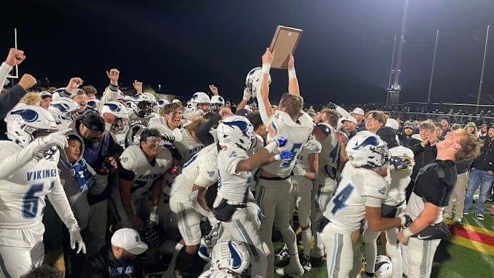 Pleasant Valley's Gavin Garretson holds up the trophy help the Vikings win the Northern Section title in 2023