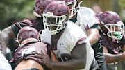 OL Jakobe Green makes a block during a Niceville Eagles football practice.