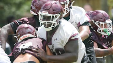 OL Jakobe Green makes a block during a Niceville Eagles football practice.