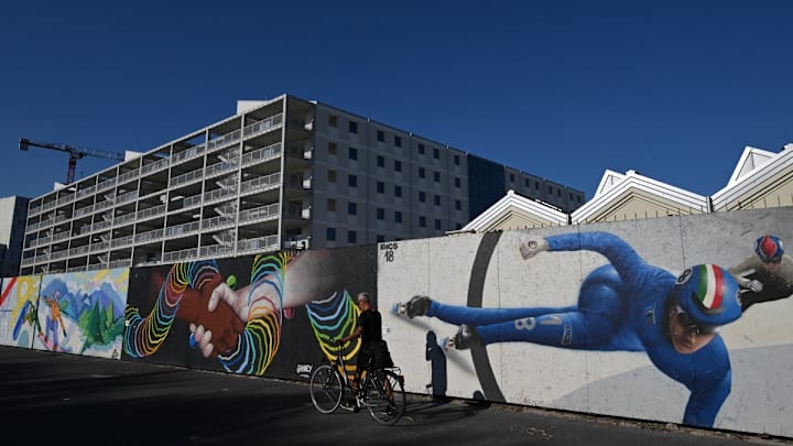 Un ciclista local pasa por la villa olímpica. Un ciclista local pasa por la villa olímpica.