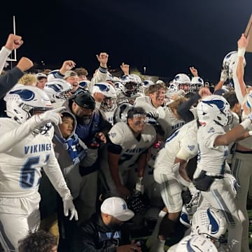 Pleasant Valley holds up the trophy after helping the Vikings win the Northern Section