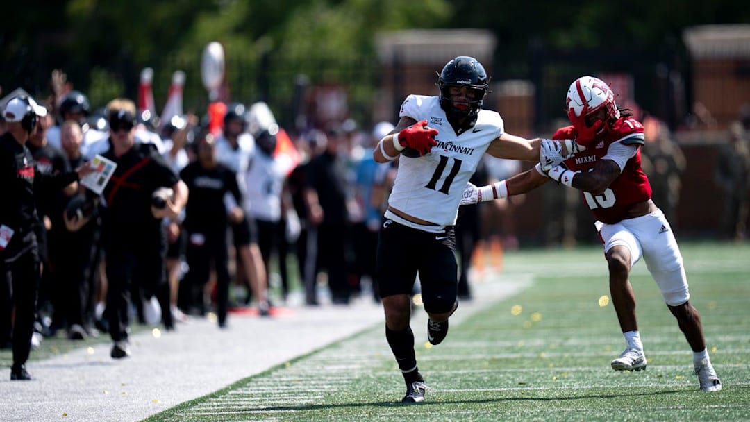 Cincinnati Bearcats tight end Joe Royer (11) stiff arms Miami Redhawks linebacker Oscar McWood (23) before the play is called back for holding in the fourth quarter of the College Football game at Yager Stadium in Cincinnati on Saturday, Sept. 14, 2024.