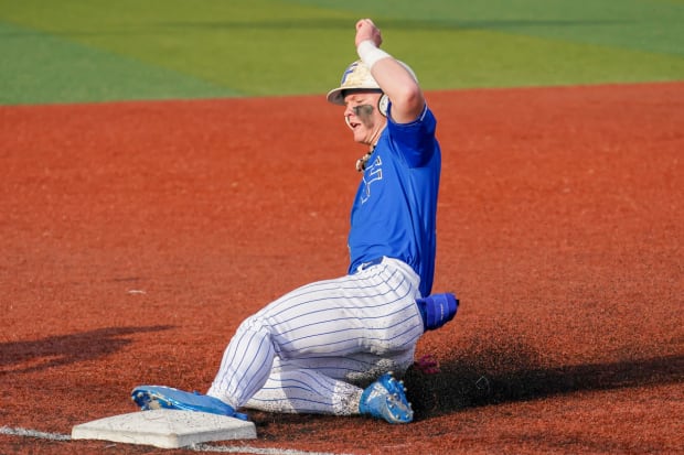 Max Clark slides into third for his Franklin Community High School (Indiana) baseball team.