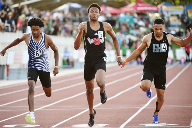 Brandon Arrington Jr. (middle), a sophomore from Mt. Miguel of Spring Valley (Calif.), wins the 100 meters finals in the CIF State Track and Field Championships with a wind-aided time of 10.33 at Buchanan High School in Clovis.  Arrington also won the 200 meters final.