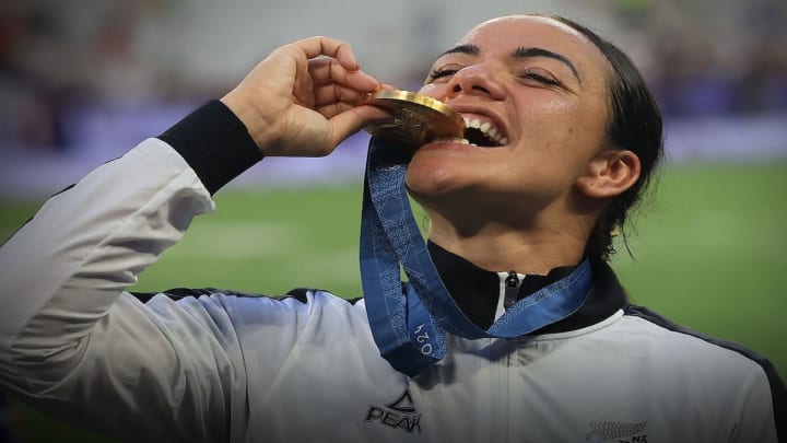 Sarah Hirini celebrates her gold medal victory, despite enduring significant pain during the final match