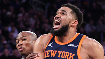 New York Knicks center Karl-Anthony Towns drives past Dallas Mavericks forward Kai Jones.
