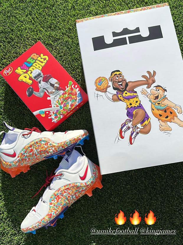 LeBron James' white and orange Nike football cleats and box.