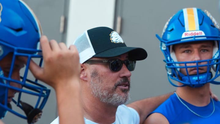 The First Academy football coach Jeff Conaway takes a moment to talk his players during a summer workout. The FHSAA on Thursday shortened his suspension to six games for the 2025 season after originally banning Conaway from coaching for the entire season due to rules violations last fall. The First Academy football coach Jeff Conaway takes a moment to talk his players during a summer workout. The FHSAA on Thursday shortened his suspension to six games for the 2025 season after originally banning Conaway from coaching for the entire season due to rules violations last fall.