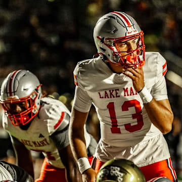 Lake Mary quarterback Noah Grubbs (13), shown here in an earlier game against Bishop Moore, completed 23 of 34 passes for 309 yards and two touchdowns and ran for another score to power the Rams to a 31-26 upset of defending Class 7A state champ Venice in a state semifinal game on Friday, Dec. 5, 2025.  The victory catapulted Lake Mary to No. 1 in this week's High School on SI Central Florida Top 10 Football rankings.