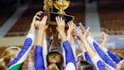 Member of Xavier College Prep's volleyball team hoist the Arizona High School Class 6A state championship trophy after beating Corona del Sol, 3-0, for the title.