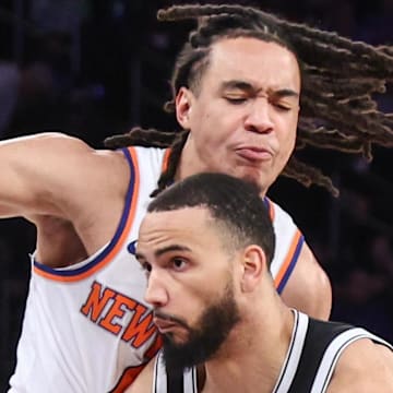 Brooklyn Nets guard Tyrese Martin drives past New York Knicks forward Pacome Dadiet.