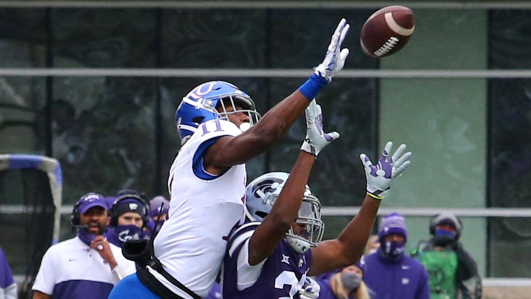 Kansas State Wildcats DB Aamaris Brown (21) breaks up a pass intended for Kansas Jayhawks WR Ezra Naylor II (11)